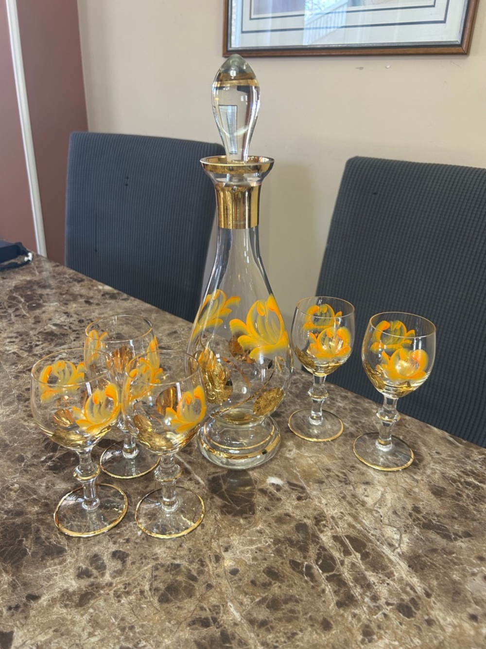Vintage gold leaf decorated glass decanter and five wine glasses